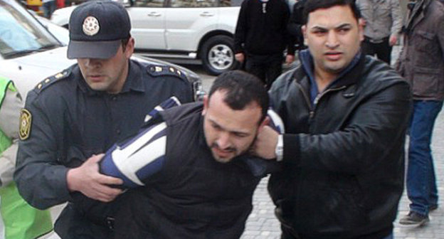 Policemen detaining a protester at the oppositional rally in Baku, April 17, 2011. Courtesy by the "Turan" Information Agency Policemen detaining a protester at the oppositional rally in Baku, April 17, 2011. Courtesy by the "Turan" Information Agency