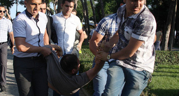 Azerbaijan, Baku, May 25, 2012: men in civilian clothes detain participants of promenade in Primorskiy Boulevard. Courtesy of the IA "Turan" Azerbaijan, Baku, May 25, 2012: men in civilian clothes detain participants of promenade in Primorskiy Boulevard. Courtesy of the IA "Turan"