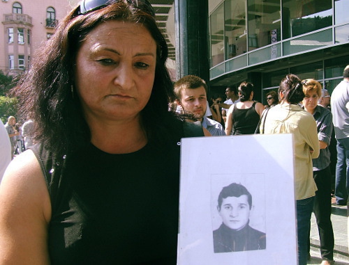 

Manana Abuseridze with a photo of her brother, who died from torture in Gldani Prison, Tbilisi, September 19, 2012. Photo by Edita Badasyan for the "Caucasian Knot"