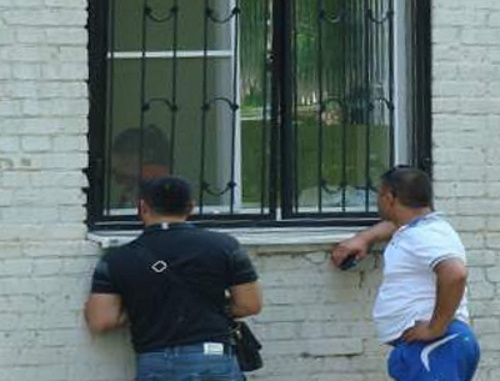 Fathers of infected children comunicate with their wives through the bars in the windows of the infection ward of the Central City Hospital of Rostov-on-Don; June 2013. Courtesy of the http://donnews.ru Fathers of infected children comunicate with their wives through the bars in the windows of the infection ward of the Central City Hospital of Rostov-on-Don; June 2013. Courtesy of the http://donnews.ru