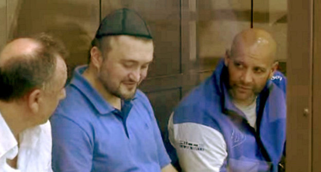 The defendants of the murder case of journalist Anna Politkovskaya Lom-Ali Gaytukaev, Rustam Makhmudov and Sergey Khadjikurbanov before the session. Moscow, June 4, 2013. Screenshot of the footage by the press-cutting service of the Moscow City Court, http://www.mos-gorsud.ru/sud/ The defendants of the murder case of journalist Anna Politkovskaya Lom-Ali Gaytukaev, Rustam Makhmudov and Sergey Khadjikurbanov before the session. Moscow, June 4, 2013. Screenshot of the footage by the press-cutting service of the Moscow City Court, http://www.mos-gorsud.ru/sud/