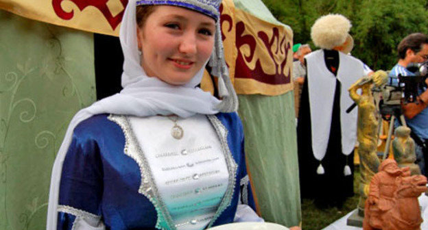 Girl in a traditional costume at the Karachay-Cherkessia cuisine exhibition presented at the youth forum of the North-Caucasian Federal District "Mashuk-2012". Pyatigorsk, July 10, 2013. Photo: official site of the head of the republic, http://www.kchr.ru/ Girl in a traditional costume at the Karachay-Cherkessia cuisine exhibition presented at the youth forum of the North-Caucasian Federal District "Mashuk-2012". Pyatigorsk, July 10, 2013. Photo: official site of the head of the republic, http://www.kchr.ru/