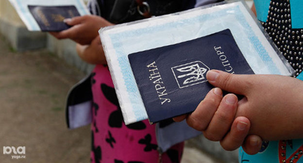 Ukrainian resettler holding a Ukranian passport. Photo: Eduard Kornienko, YUGA.ru, http://www.yuga.ru/media/3c/6c/ek_8026__hefdzn4.jpg Ukrainian resettler holding a Ukranian passport. Photo: Eduard Kornienko, YUGA.ru, http://www.yuga.ru/media/3c/6c/ek_8026__hefdzn4.jpg