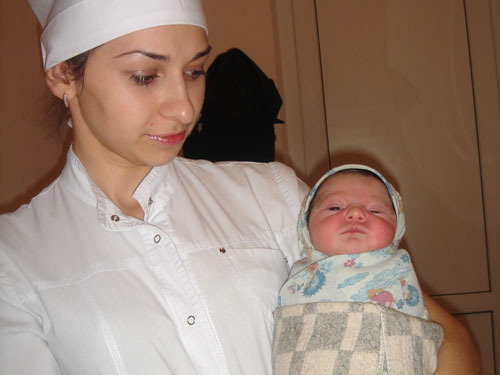 A newborn girl and Alisa Bechvaya, a nurse of Sukhumi maternity hospital. January 19, 2010. Photo by the "Caucasian Knot" A newborn girl and Alisa Bechvaya, a nurse of Sukhumi maternity hospital. January 19, 2010. Photo by the "Caucasian Knot"
