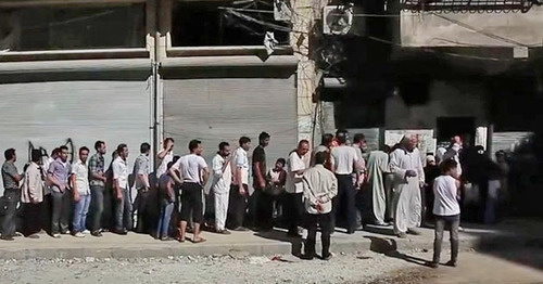 The Aleppo residents are queuing outside a bakery in order to buy bread. Syria. Photo https://ru.wikipedia.org