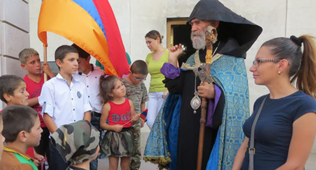 Archbishop Pargev Martirosyan, the leader of the Artsakh Diocese of the Armenian Apostolic Church, had a talk with children in Maraga village and blessed them after
the liturgy for the repose of the two soldiers lost on September 4 in the Karabakh conflict zone. Stepanakert, Nagorno-Karabakh. September 6, 2015. Photo by Alvard Grigoryan for the "Caucasian Knot"