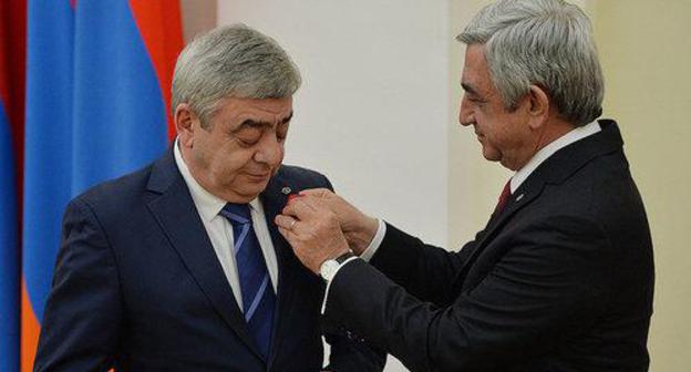 Serzh Sargsyan, a President of Armenia, gives an award to his brother Levon Sargsyan. Photo by the press service of the President of Armenia http://www.president.am Serzh Sargsyan, a President of Armenia, gives an award to his brother Levon Sargsyan. Photo by the press service of the President of Armenia http://www.president.am