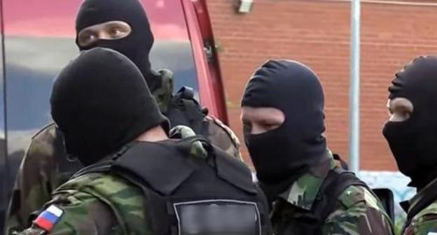 Law enforcers in masks. Screenshot of the video https://www.youtube.com/watch?v=ZsKHG3JRbso Law enforcers in masks. Screenshot of the video https://www.youtube.com/watch?v=ZsKHG3JRbso