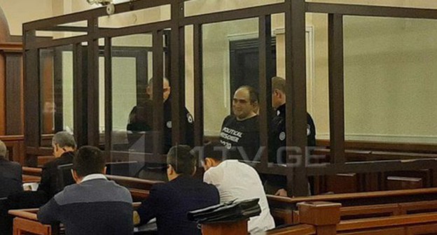 Giorgi Rurua in the courtroom. Screenshot from video posted by TV Channel 1tv: https://1tv.ge/ru/news/sud-ostavil-georgija-rurua-v-zakljuchenii/ Giorgi Rurua in the courtroom. Screenshot from video posted by TV Channel 1tv: https://1tv.ge/ru/news/sud-ostavil-georgija-rurua-v-zakljuchenii/