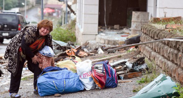 A woman rendered homeless gathers her belongings, October 6, 2020. David Kagramanyan / the information centre of NKR / PAN Photo / Reuters A woman rendered homeless gathers her belongings, October 6, 2020. David Kagramanyan / the information centre of NKR / PAN Photo / Reuters