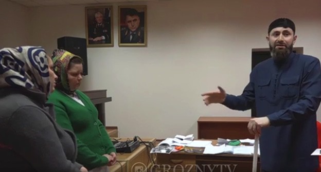 Adam Elzhurkaev, a theologian, is reprimanding Lida Ausheva, a native of Ingushetia, for rendering occult services. Screenshot: https://www.instagram.com/p/CK14GxdJrdG/ Adam Elzhurkaev, a theologian, is reprimanding Lida Ausheva, a native of Ingushetia, for rendering occult services. Screenshot: https://www.instagram.com/p/CK14GxdJrdG/