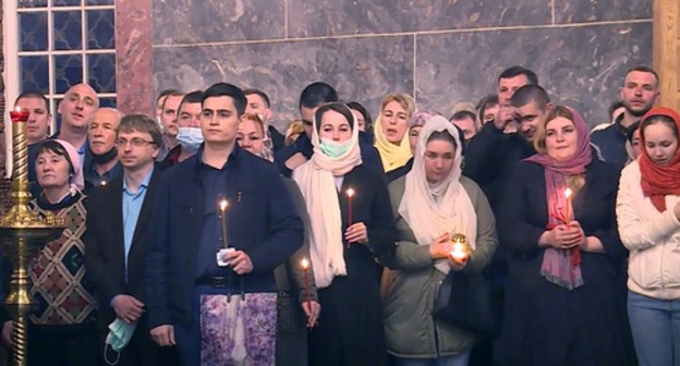 Orthodox believers at the solemn services in a church in Astrakhan. Screenshot of the video at the "ГТРК Лотос Астрахань" YouTube channel https://www.youtube.com/watch?v=X-UTkDR5OEg Orthodox believers at the solemn services in a church in Astrakhan. Screenshot of the video at the "ГТРК Лотос Астрахань" YouTube channel https://www.youtube.com/watch?v=X-UTkDR5OEg