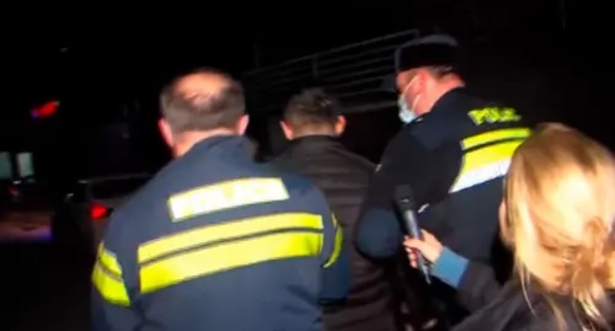Police take away the attacker on journalists. Image made from video posted by Formula channel at: https://formulanews.ge/News/66843 Police take away the attacker on journalists. Image made from video posted by Formula channel at: https://formulanews.ge/News/66843