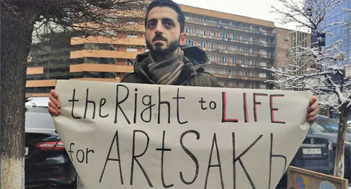 A participant of a protest action with a banner. Yerevan, March 24, 2022. Photo by Armine Martirosyan for the "Caucasian Knot" A participant of a protest action with a banner. Yerevan, March 24, 2022. Photo by Armine Martirosyan for the "Caucasian Knot"