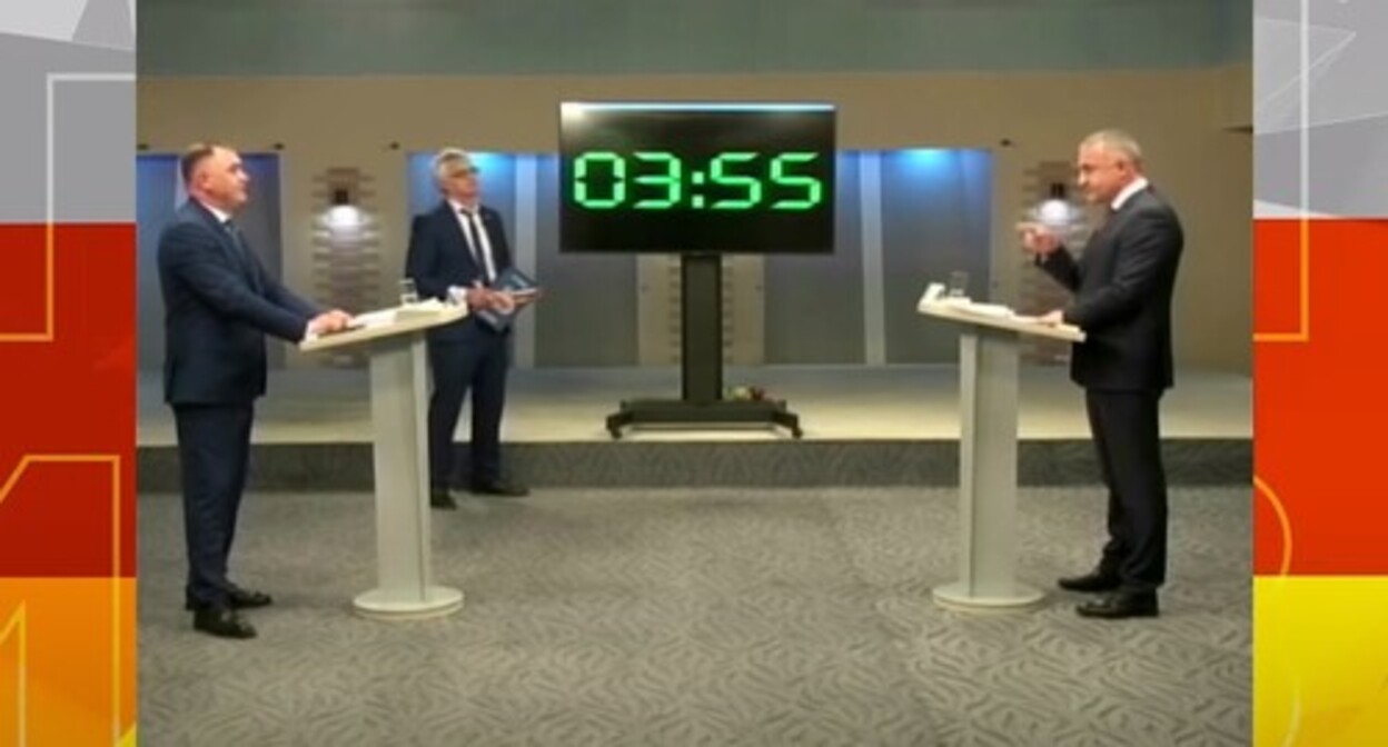 Television debates of South Ossetian presidential candidates Alan Gagloev (left) and Anatoly Bibilov (right) on April 25, 2022. Screenshot: http://gtrkir.ru/news/ii-tur-predvibor-0 Television debates of South Ossetian presidential candidates Alan Gagloev (left) and Anatoly Bibilov (right) on April 25, 2022. Screenshot: http://gtrkir.ru/news/ii-tur-predvibor-0
