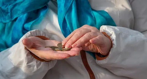 A pensioner holds money in her hands. Photo courtesy of Nina Tumanova A pensioner holds money in her hands. Photo courtesy of Nina Tumanova