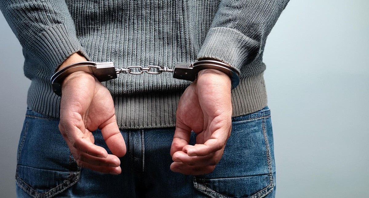 A man in handcuffs. Picture made in Photoshop by the "Caucasian Knot"