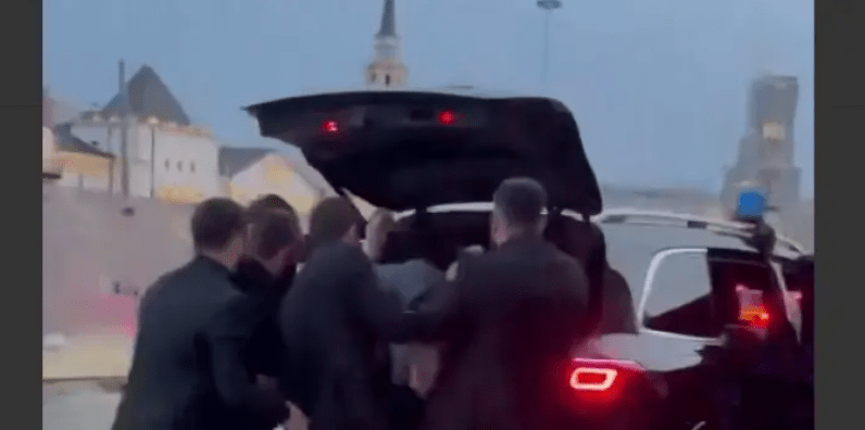 Chechen enforcers put Areg Shchepikhin in the trunk. Still image of Caucasian Knot video, https://www.youtube.com/shorts/lqkgd7MfIM8