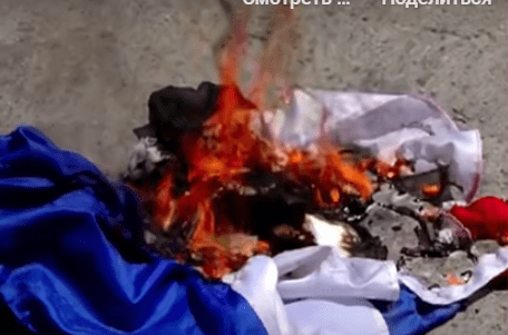 Russian flag burned in Georgia. Still frame from Pirveli TV company video from 27.07.25, https://www.youtube.com/watch?v=gwB1cRuEWBk&t=325s