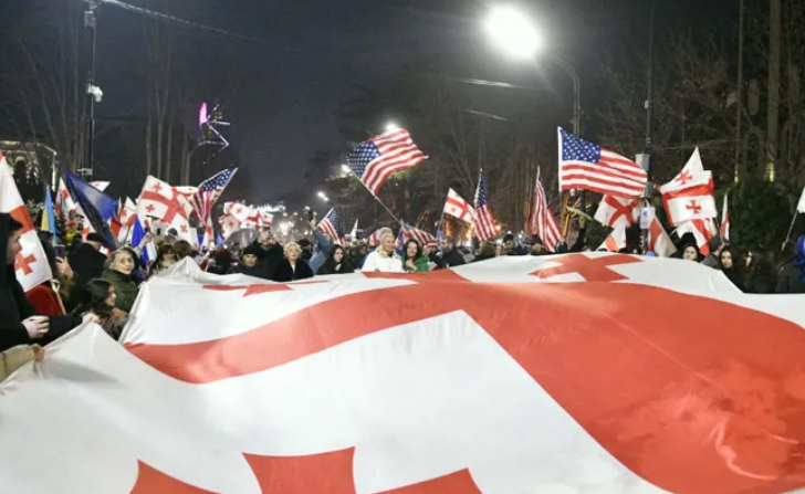 Protest outside the Georgian Parliament. Screenshot from Interpressnews photo from February 7, 2026, https://www.interpressnews.ge/ka/article/861329-parlamenttan-akcia-mimdinareobs
