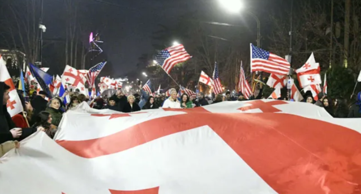 Protest outside the Georgian Parliament. Screenshot from Interpressnews photo from February 7, 2026, https://www.interpressnews.ge/ka/article/861329-parlamenttan-akcia-mimdinareobs