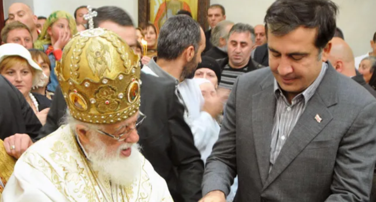 Ilia II and Mikheil Saakashvili. Screenshot from Interpressnews photo from March 19, 2026, https://www.interpressnews.ge/ru/article/173886-mikhail-saakashvili-proshu-dostavit-menia-na-pokhorony-patriarcha-kak-ego-druga-tretego-prezidenta-gruzii