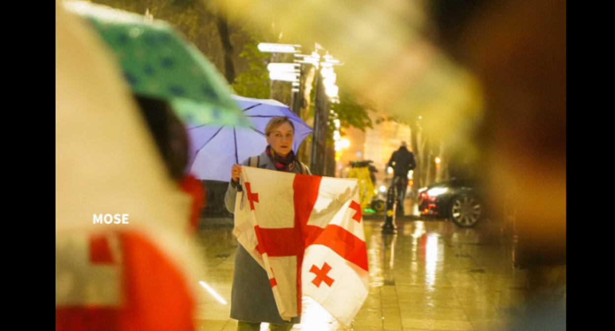 An activist outside the Georgian parliament. Screenshot of a photo by Mo Se from April 12, 2026, https://www.facebook.com/photo?fbid=4276759392638800&set=pcb.4276760289305377 (Meta, the company that owns the social network, is banned in Russia).