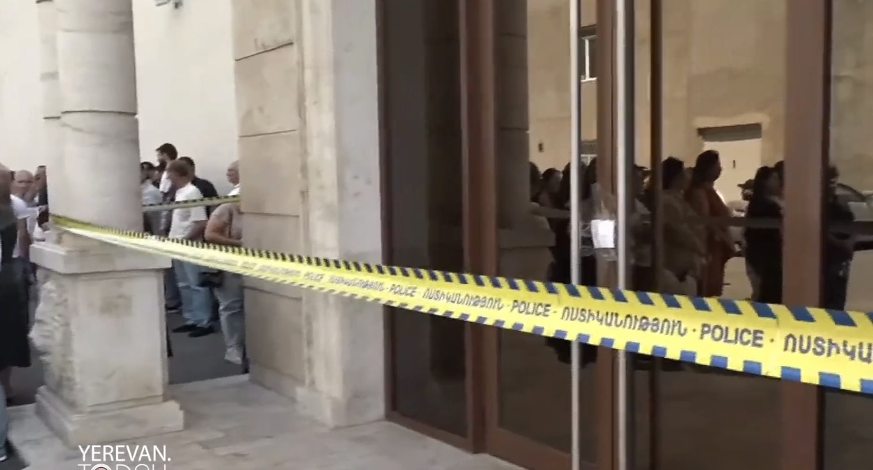 Employees of "Multi Tobacco" at the sealed entrance to the enterprise, July 14, 2026. Frame from video Yerevan Today / YouTube